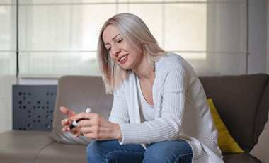 woman measuring blood sugar